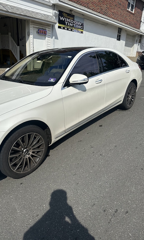 White Mercedes-Benz S-Class sedan freshly tinted outside the MAIGA shop
