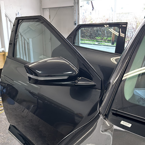 Black SUV with door open showing tinted windows